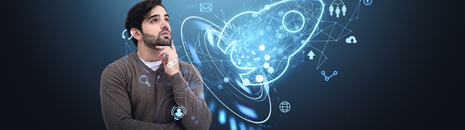 A man contemplates a futuristic holographic rocket surrounded by business icons, on a dark background. Concept of startup growth and innovation