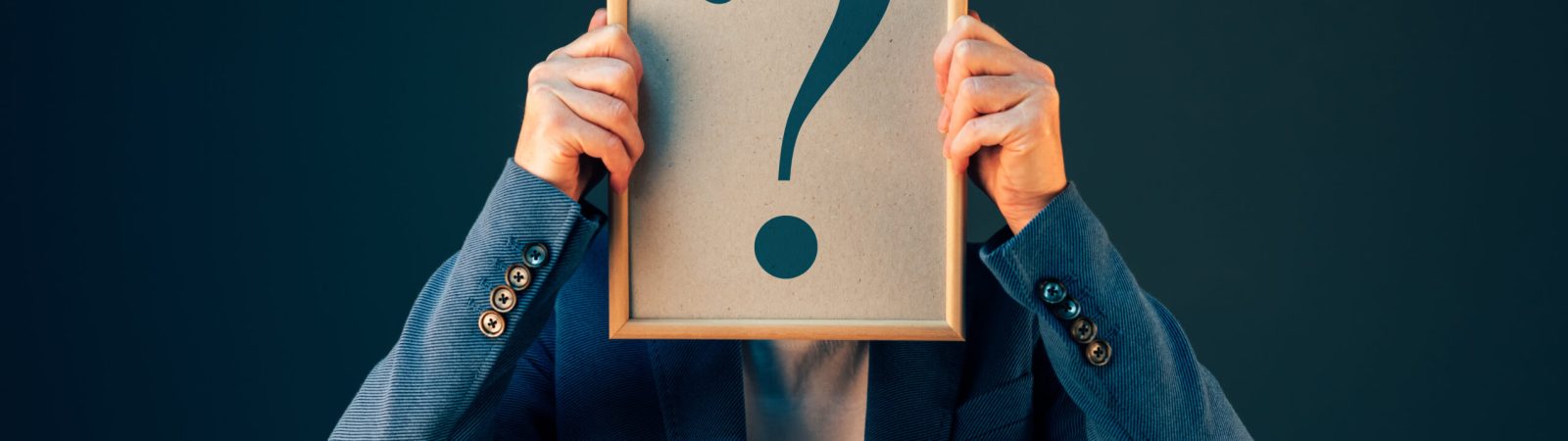 Businesswoman with question mark looking for answers, questioning and wondering about uncertain future in corporate business