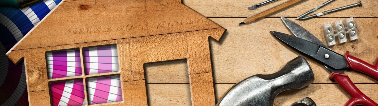 Home improvement concept - Wooden model house on a work table with tools