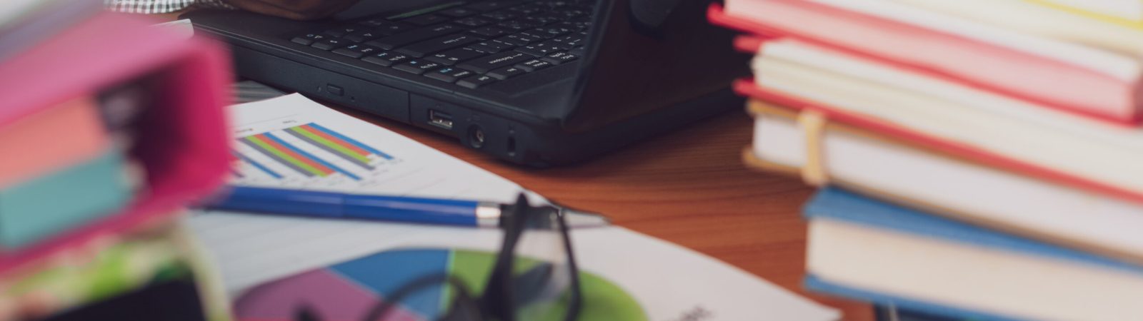 Man is using mobile phone and working with stack of documents on office desk, Businessman is analyzing marketing with statistics chart, Business and Office life concept.