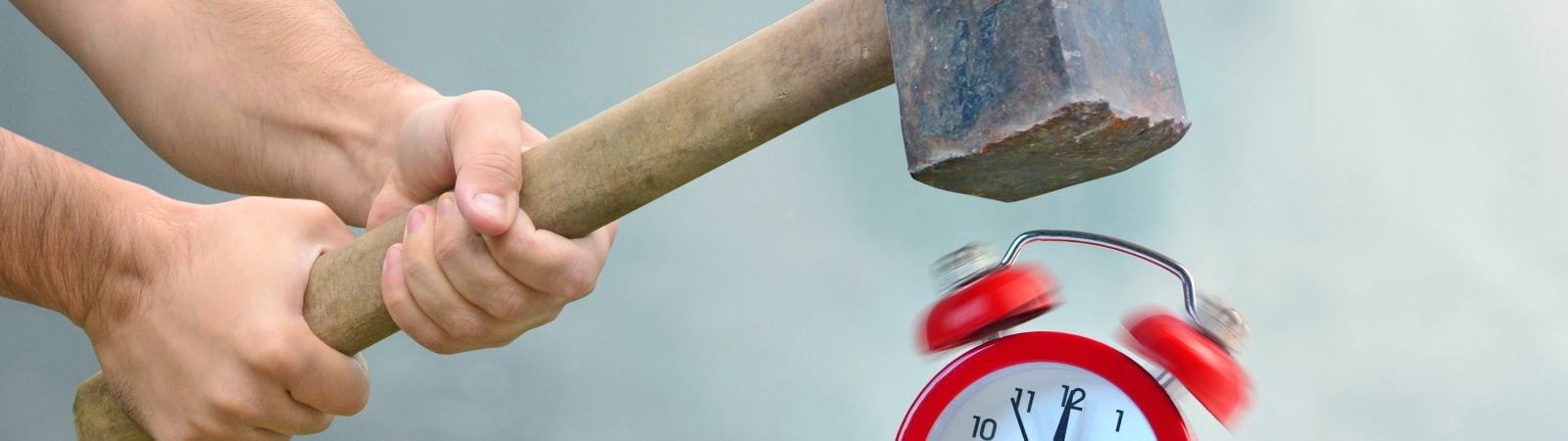 Early awakening with ringing alarm clock. Man with big hammer going to destroy morning alarm clock. Concept of breaking rules.