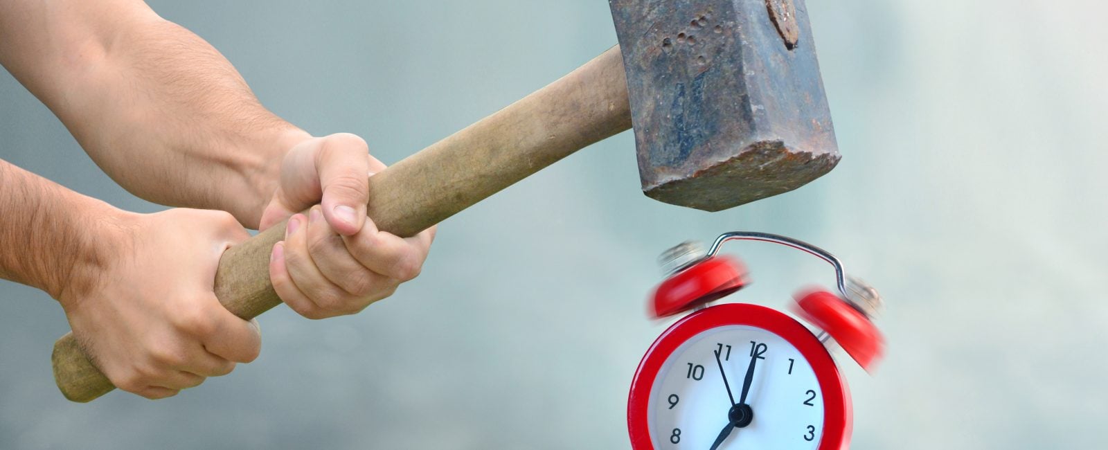 Early awakening with ringing alarm clock. Man with big hammer going to destroy morning alarm clock. Concept of breaking rules.