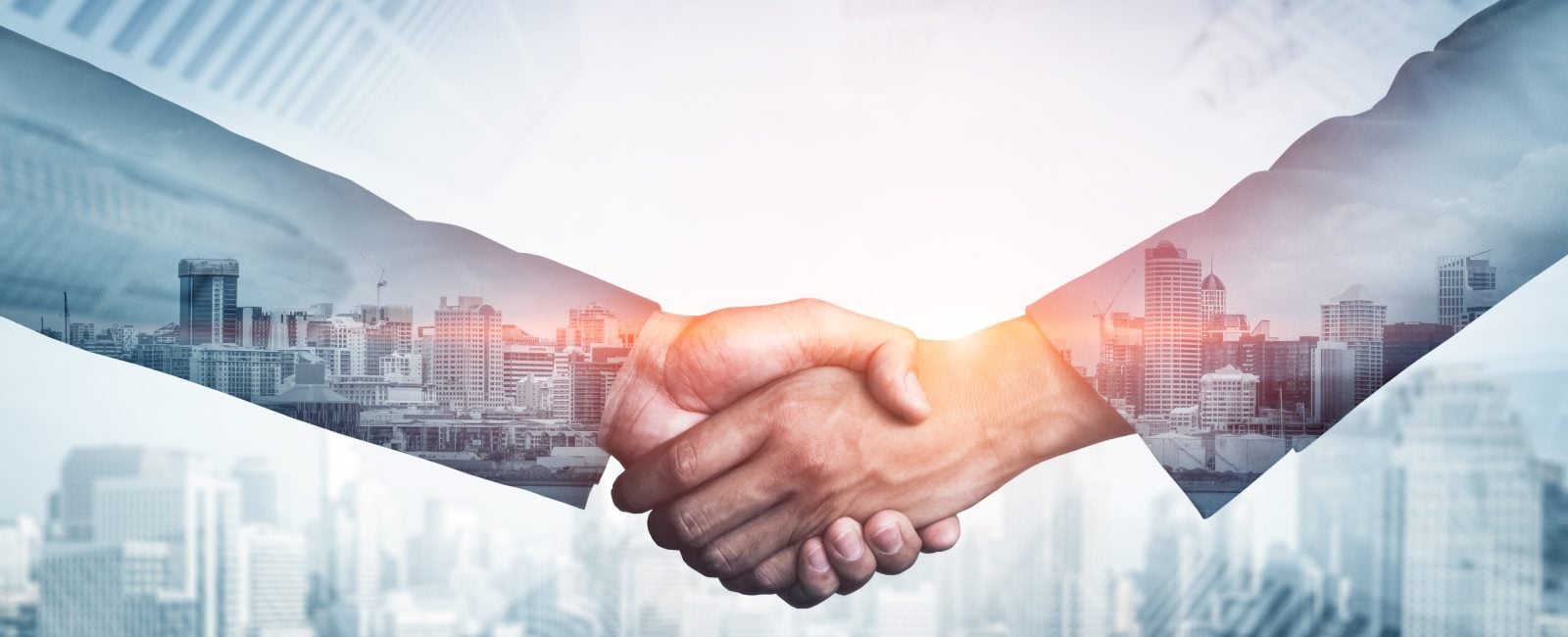 Double exposure image of business people handshake on city office building in background showing partnership success of business deal. Concept of corporate teamwork, trust partner and work agreement.
