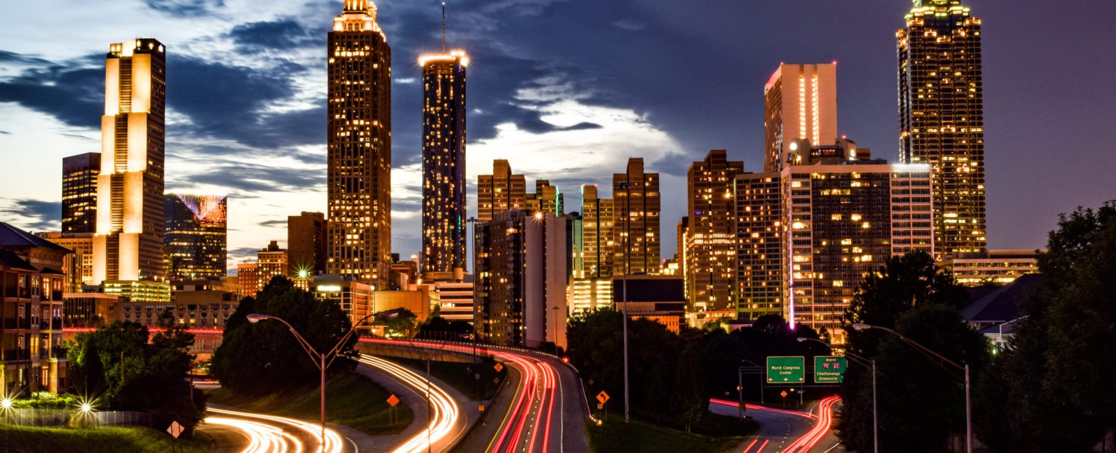Skyline of Downtown Atlanta and Blurred Highway Traffic at Dusk