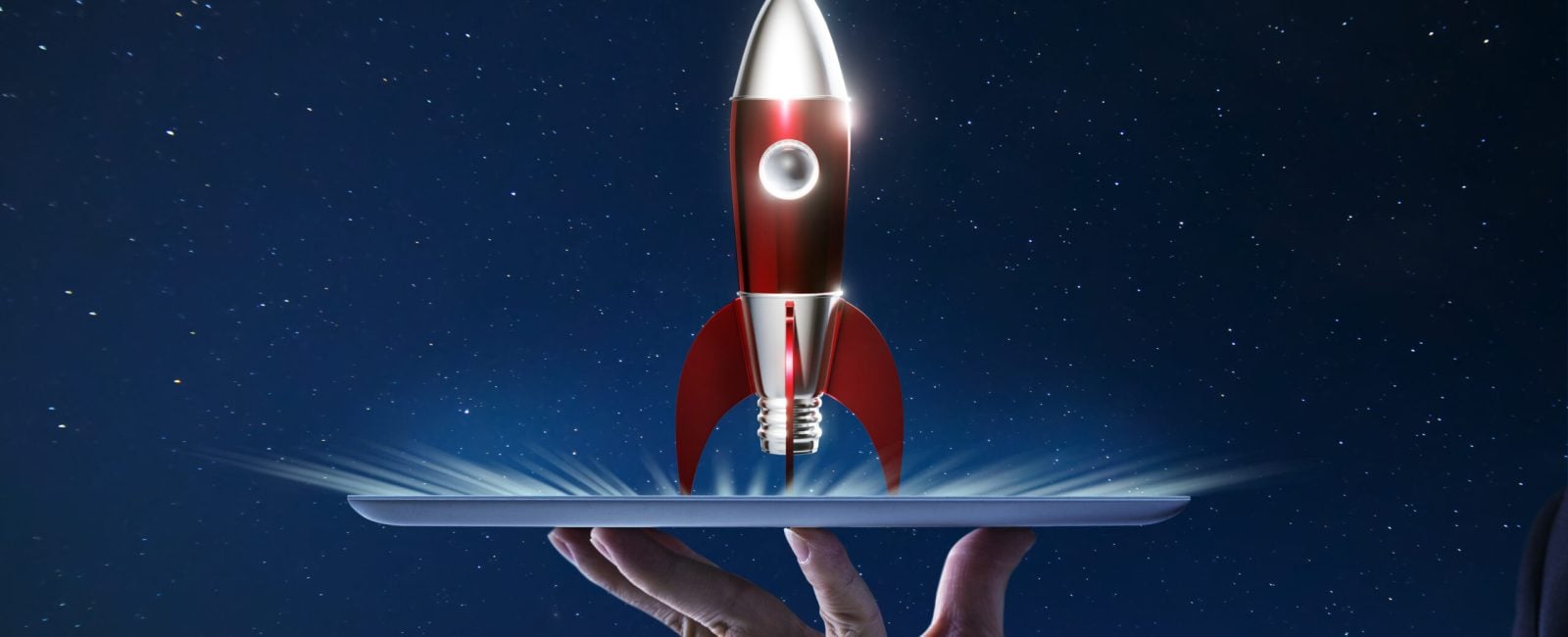 Waiter hand holding an empty digital tablet with Metallic red antique style rocket space ship , Startup creative concept .