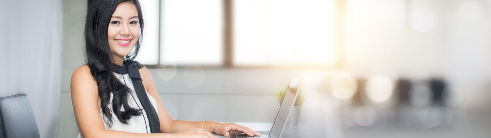portrait of business woman sitting in office with happy smiled