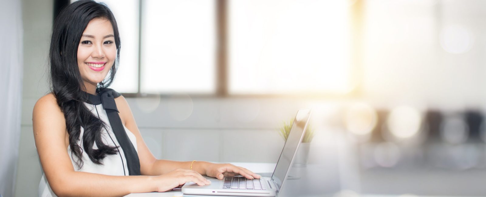 portrait of business woman sitting in office with happy smiled