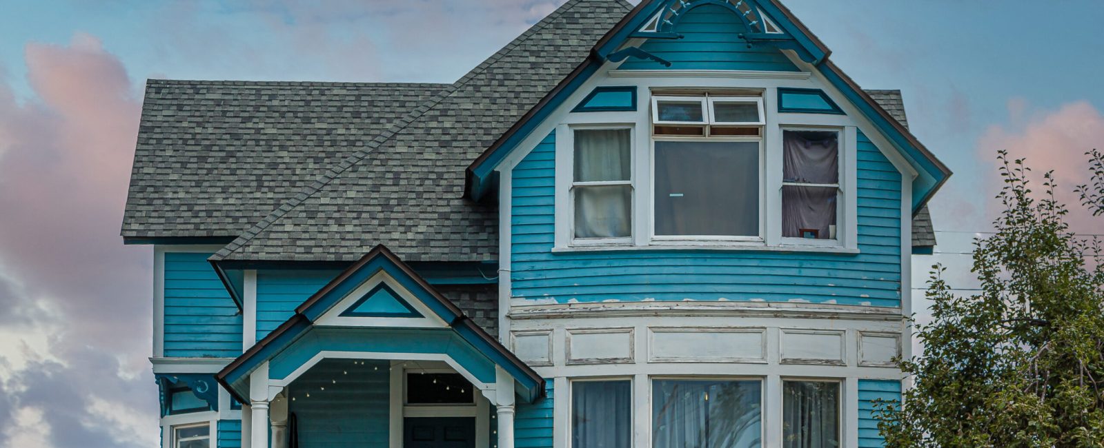 A Blue Victorian House on Hill