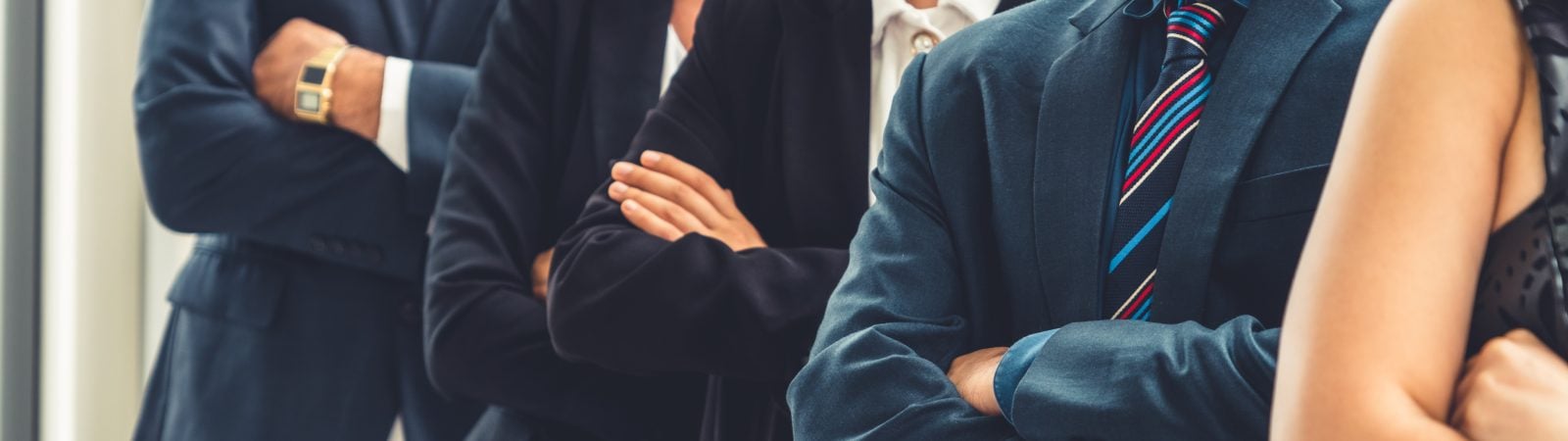 Successful business people standing together showing strong relationship of worker community. A team of businessman and businesswoman expressing a strong group teamwork at the modern office.