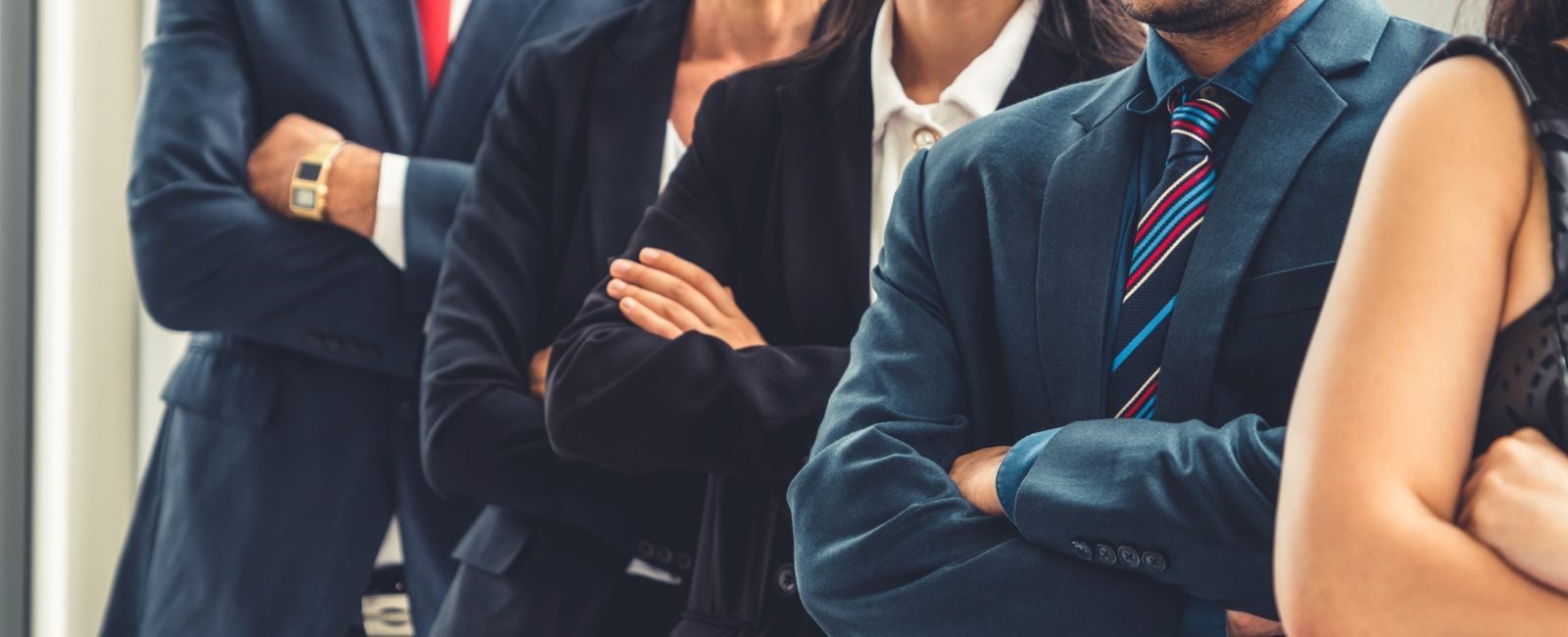 Successful business people standing together showing strong relationship of worker community. A team of businessman and businesswoman expressing a strong group teamwork at the modern office.