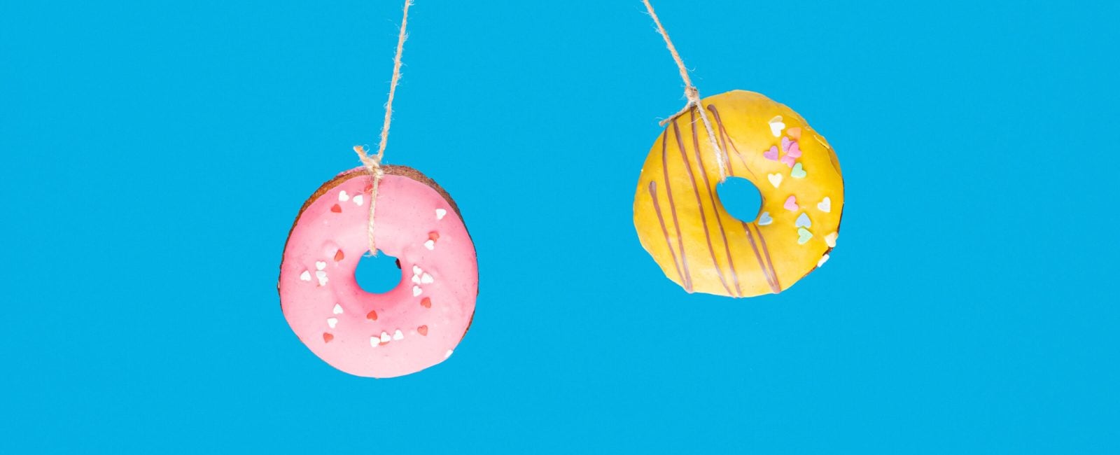 Momentum and time, collision concept with two donuts on blue background.