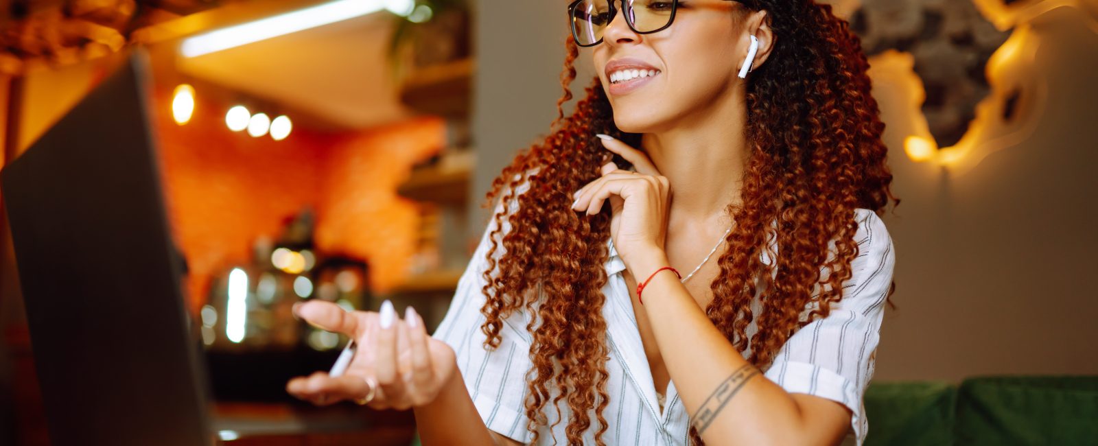 Portrait of African American woman sitting at cafe having video