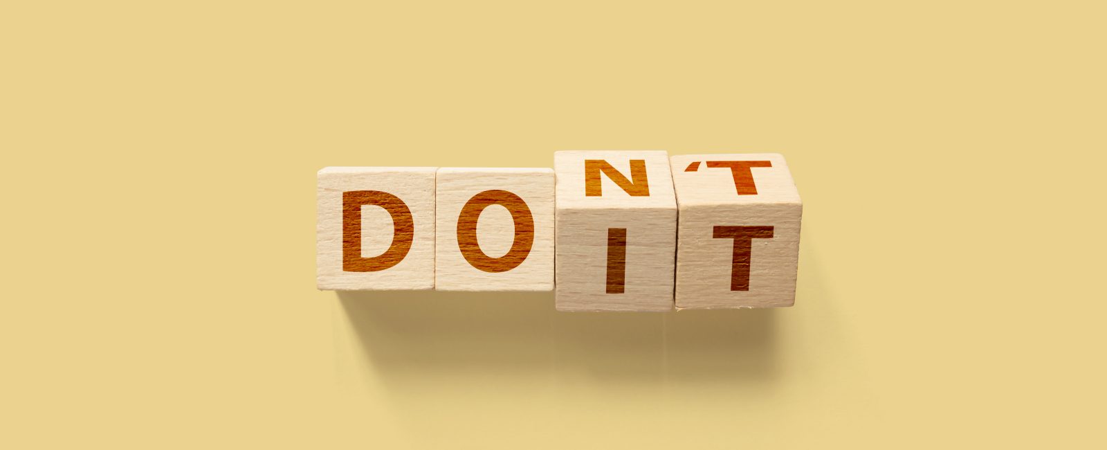Do it or Don't concept. Wooden cube shape flip change the word
