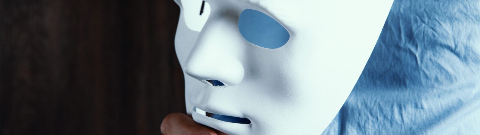 businessman puts on white mask