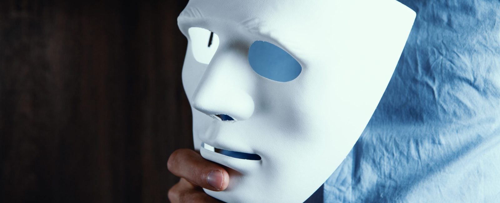 businessman puts on white mask
