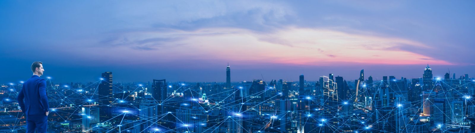 Professional business man looking on future smart city background and futuristic interface graphic at night. Business technology concept.