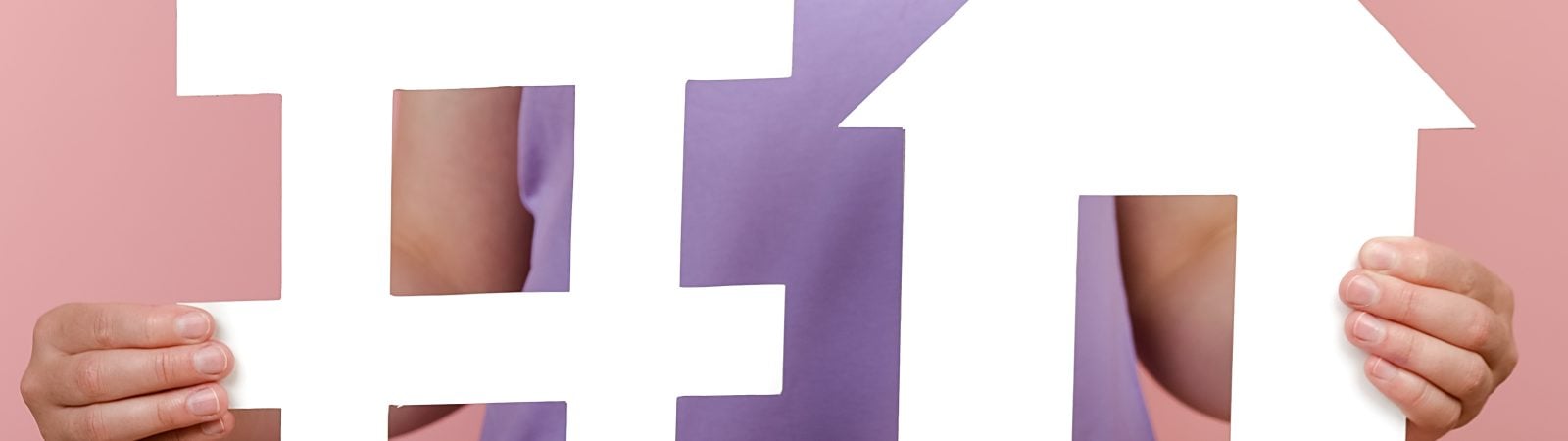 Closeup of unrecognizable woman holds white hashtag sign and house model, label for business, marketing, advertising, isolated on pink wall. Social network monitoring, media measurement, mortgage