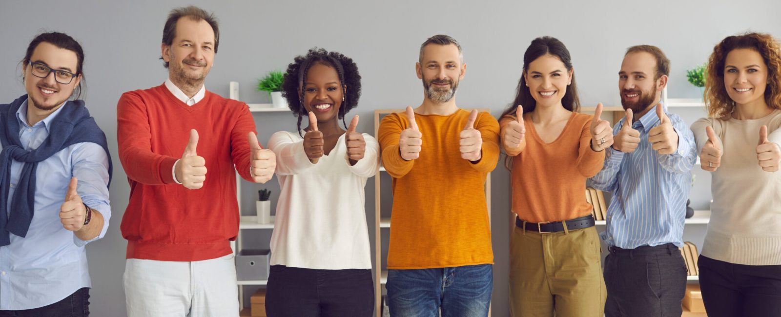 Happy smiling multi ethnic businesspeople diverse showing thumbs up together looking at camera. Business team with like gesture recommend good quality coworking or training course, group therapy