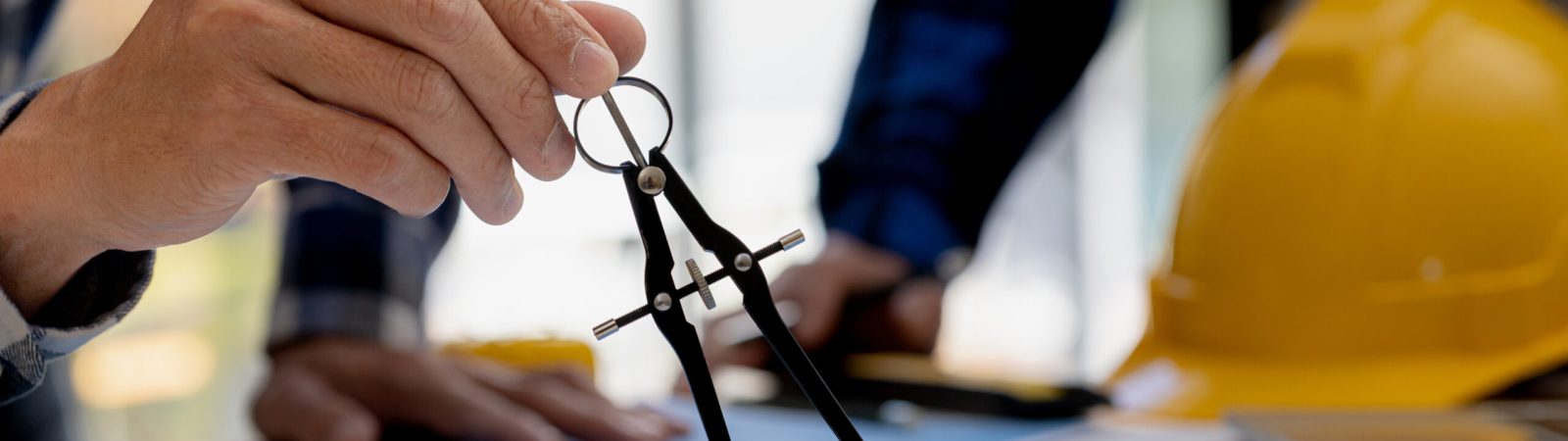 Architects use compasses to draw on building plans for editing, architect engineers design houses and interior structures and draw plans through design programs. Architect concept of building design.