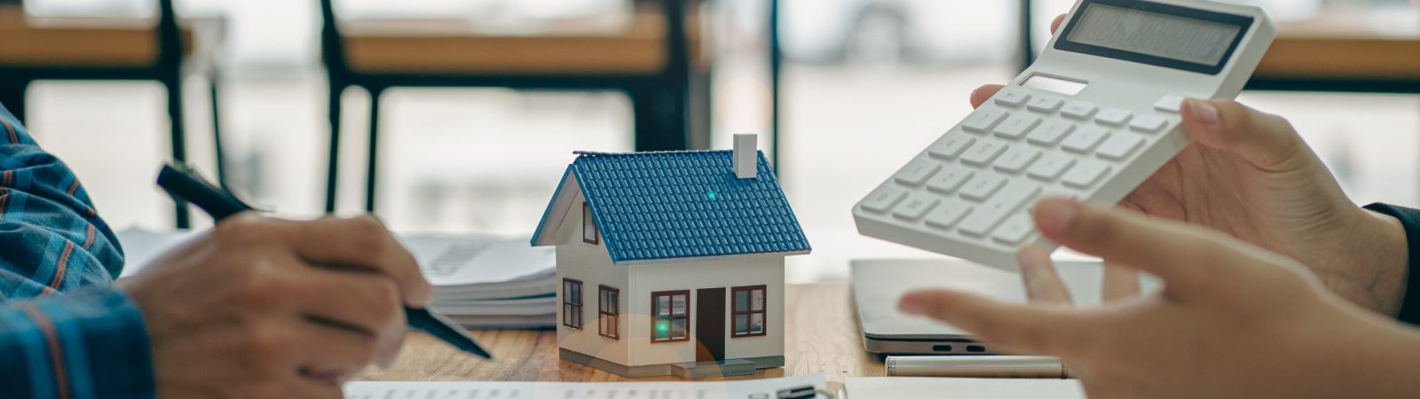 Real estate agents recommend homes and offer insurance interest rate contracts to clients in the home buying idea office.