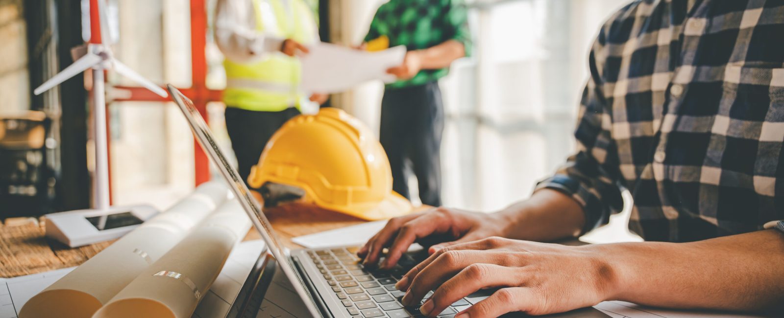 Engineers work as a team with blueprints for architectural plans. Engineer sketching construction project concept with architect equipment Architects talking at table Teamwork and construction concept