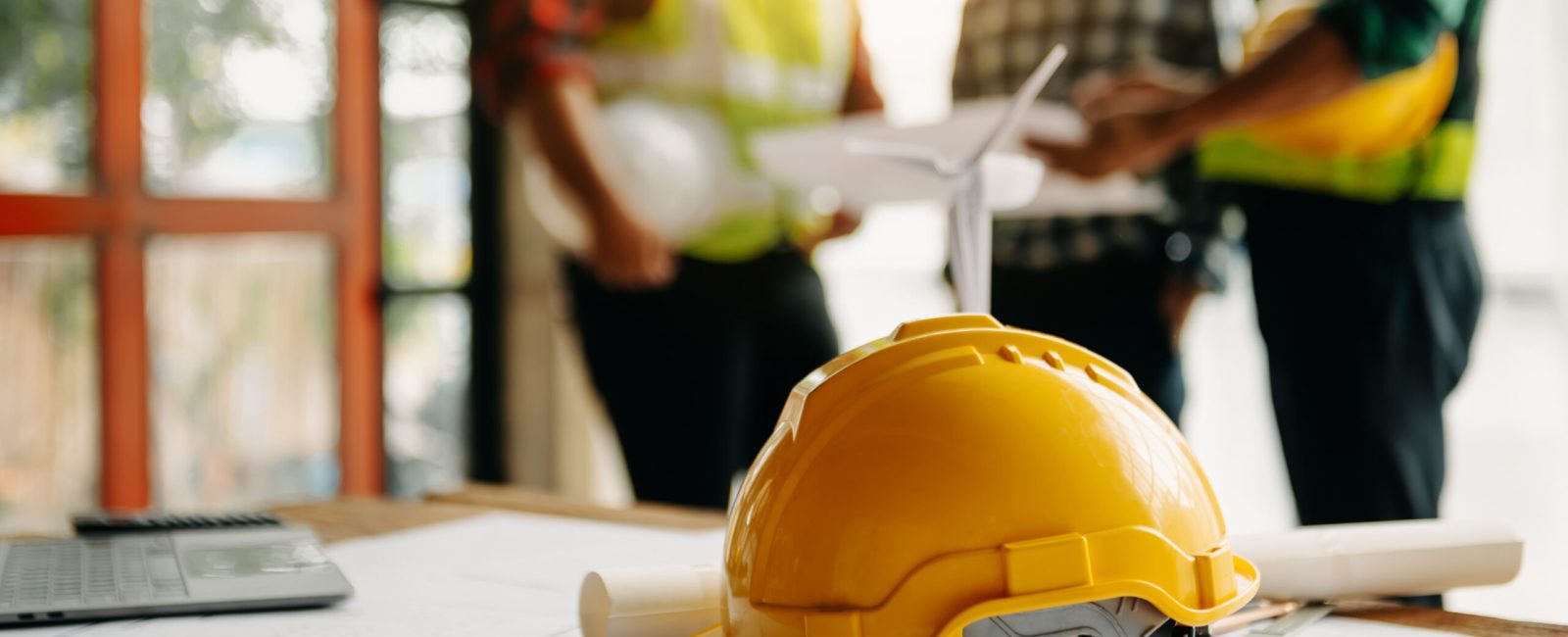 Engineer teams meeting working together wear worker helmets hardhat on construction site in modern city.Asian industry professional team in sun light