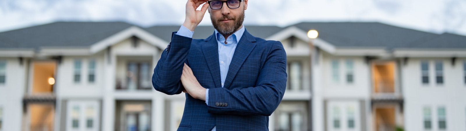 man realtor outdoor. photo of man realtor. man realtor at the house. man realtor in the suit.
