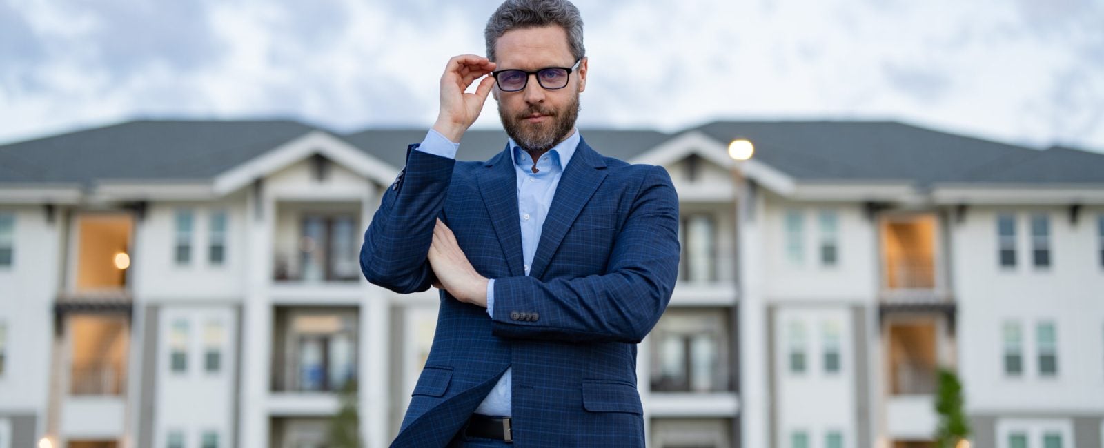man realtor outdoor. photo of man realtor. man realtor at the house. man realtor in the suit.