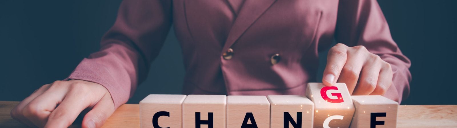Businesswoman hand flipping wooden blocks with CHANGE to CHANCE text. Economy investment business crisis, technology transformation can make good chance, strategy, solution, positive thinking concept.