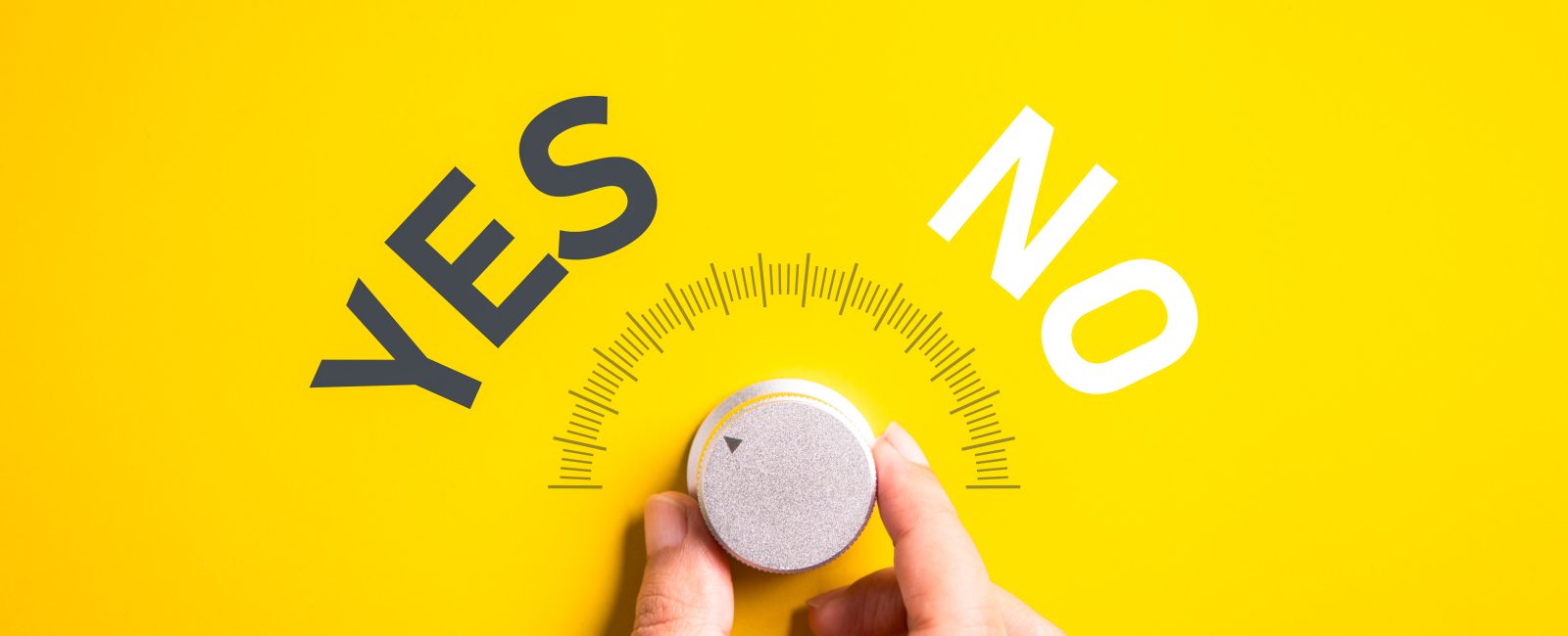 Hand adjusting the volume selector for choosing YES or NO on isolated yellow background. Questionnaire question and answer concept.