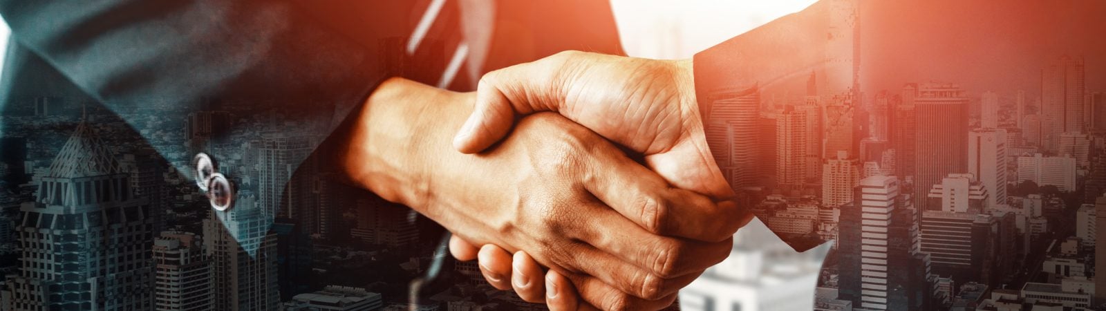 Double exposure image of business people handshake on city office building in background show partnership success of business deal. Concept of corporate teamwork, trust partner and work agreement. uds
