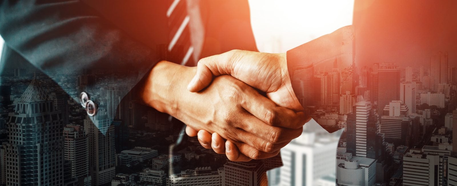 Double exposure image of business people handshake on city office building in background show partnership success of business deal. Concept of corporate teamwork, trust partner and work agreement. uds